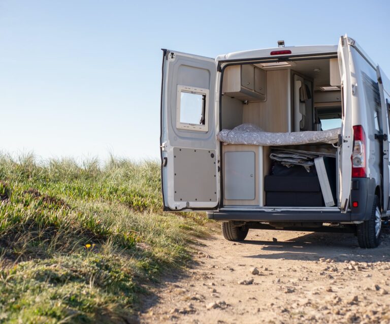 white and brown camper trailer on brown field