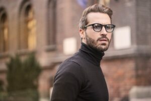 man standing near building white black turtleneck shirt - Confidence Boosting Gifts For The Man In Your Life