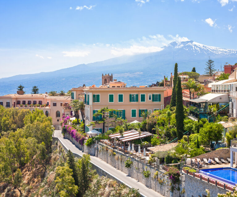 View of Taormina with Etna volcano int the back in Sicily, Italy