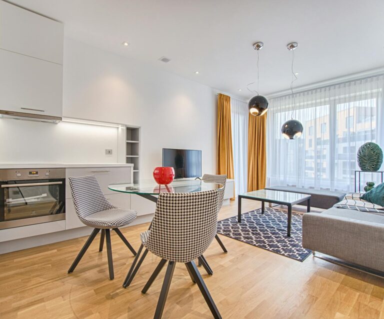 two chairs with glass table on living room near window