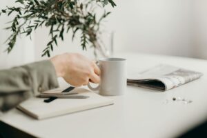 person holding white ceramic mug