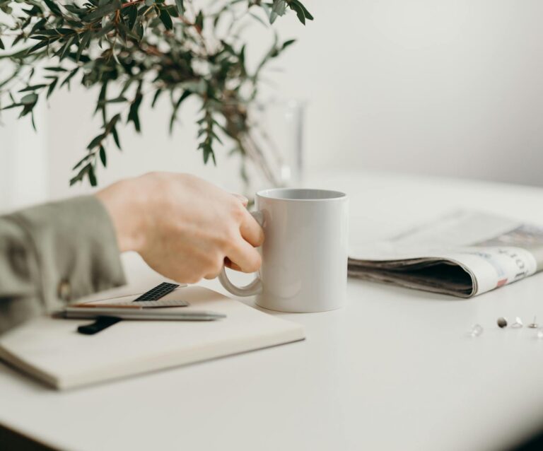 person holding white ceramic mug