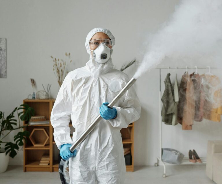 a woman fumigating while wearing a personal protective equipment