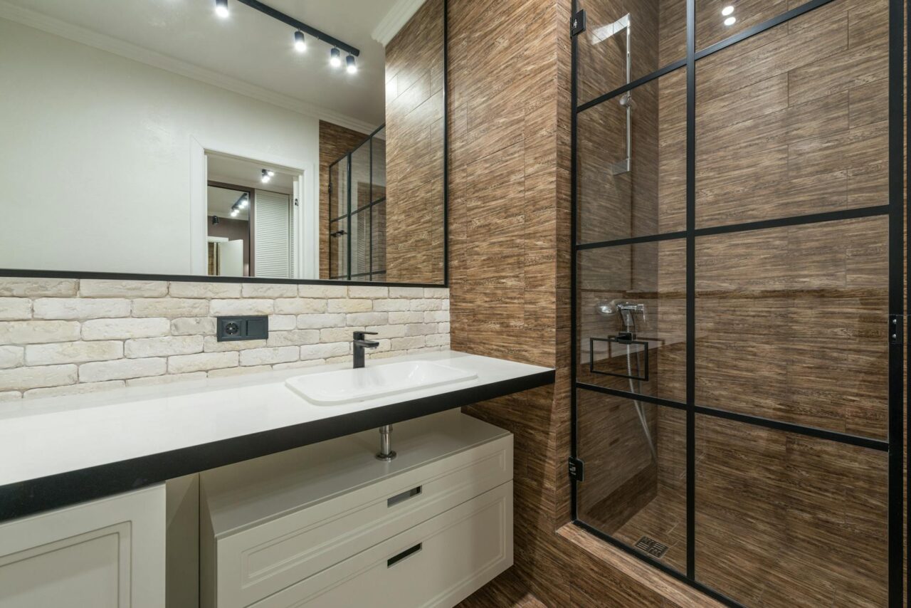 interior of modern bathroom with shower cabin and sink